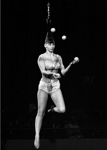 1950's female aerial juggler hanging by her hair